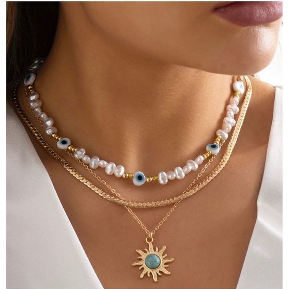 Multi strand layered necklace with evil eye faux freshwater pearls accented with - Picture 3 of 7